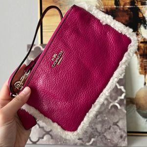 NWOT COACH PINK SMALL WRISTLET IN LEATHER AND SHEARLING (COACH F64709)